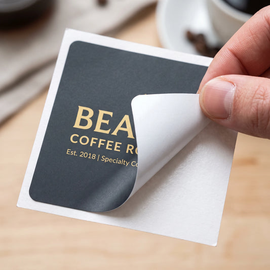 Premium matte vinyl custom packaging sticker peeling off from backing liner showing adhesive quality