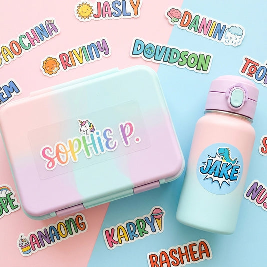 Colorful variety of custom vinyl name stickers for kids, featuring 'SOPHIE' and 'JAKE' on a lunchbox and water bottle with playful fonts and icons.